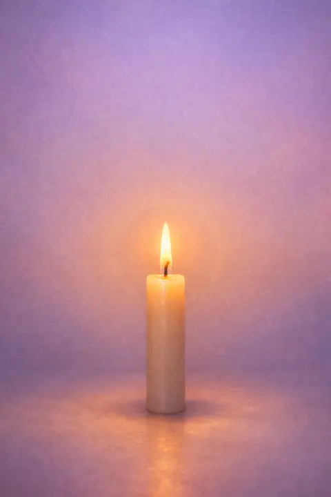 Aesthetic candle wallpaper with a single lit candle glowing softly in a dim muted room