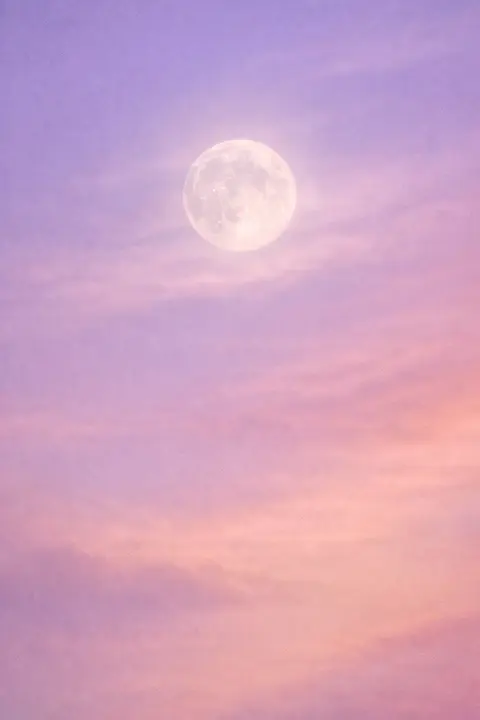 Aesthetic moon wallpaper with a pale full moon and a soft halo behind thin high cloud