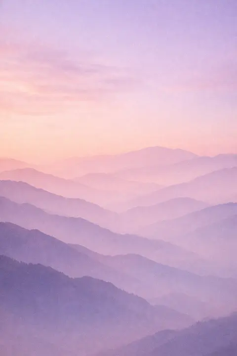 Aesthetic mountain wallpaper with layered ridges fading back through haze into a pale sky