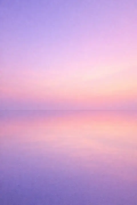 Aesthetic water wallpaper with a perfectly still stretch reflecting a pale graded sky