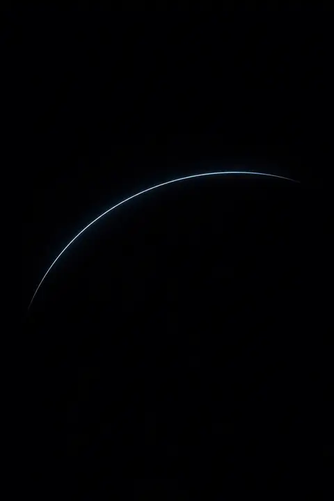 Dark minimalist wallpaper with one thin pale arc of light curving across a flat black field