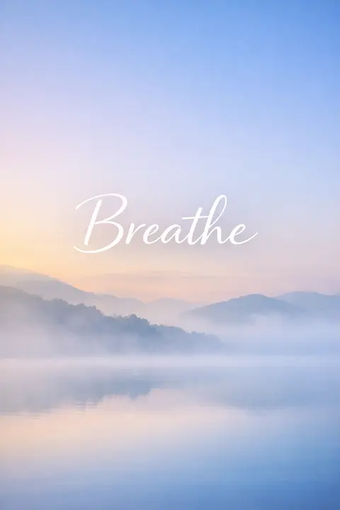Motivational wallpaper with the word Breathe over calm morning mist
