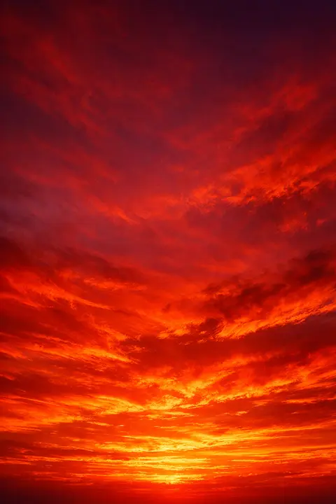 Orange sunset wallpaper with a fiery scarlet and vermilion sky burning brightest at the horizon