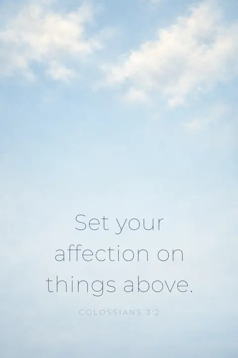 Bible verse wallpaper with Colossians 3:2 in thin sans type over pale blue clouds seen from below