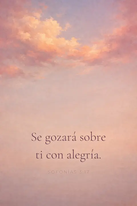 Fondo de pantalla cristiano con Sofonías 3:17 en tipografía serif sobre nubes de atardecer rosa y oro